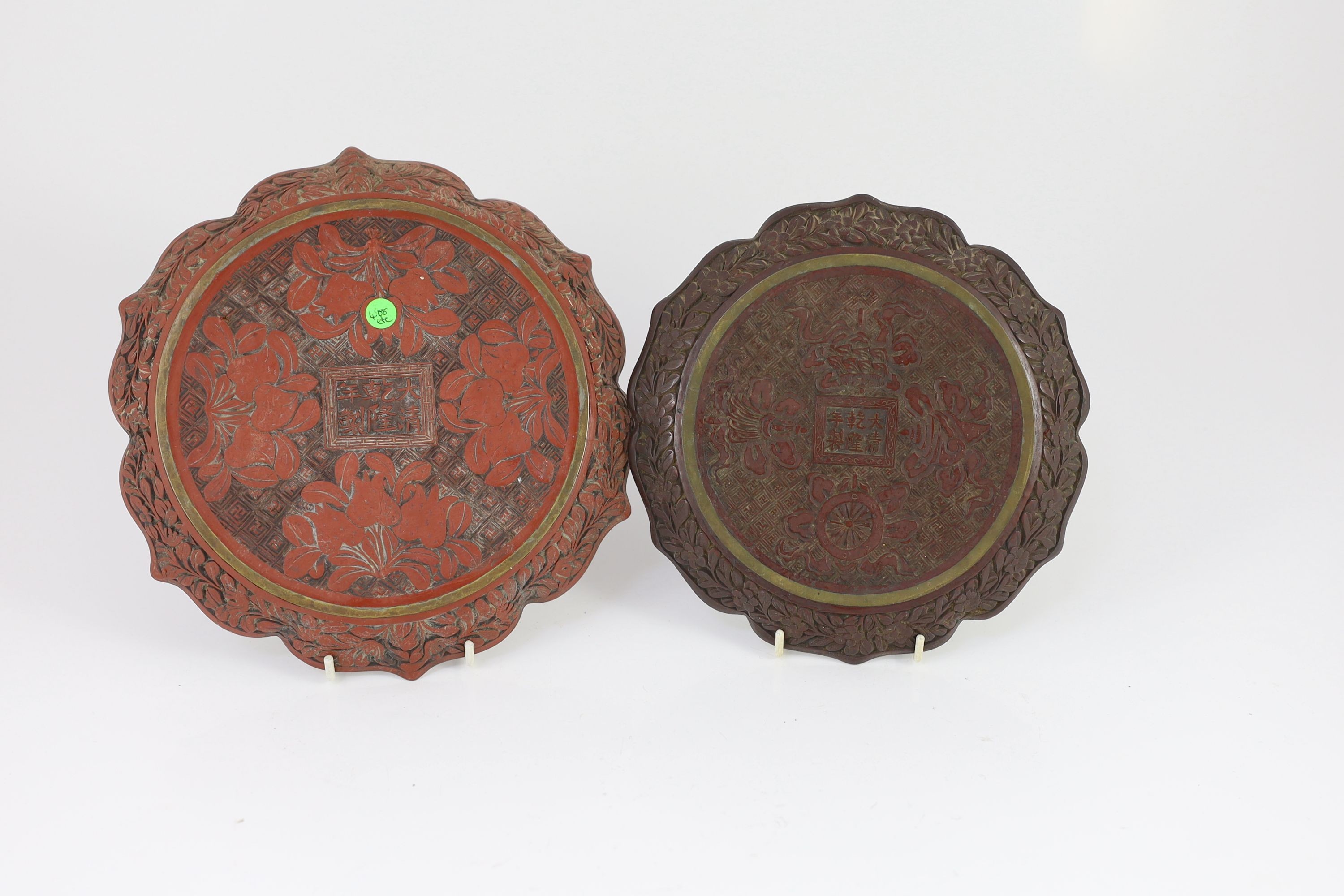 Two similar Chinese cinnabar lacquer dishes, Qianlong marks, late 19th century, 23.5cm & 20.5 cm diameter